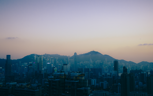 Free Captivating twilight view of Kowloon's skyline with Victoria Harbour in Hong Kong. Stock Photo