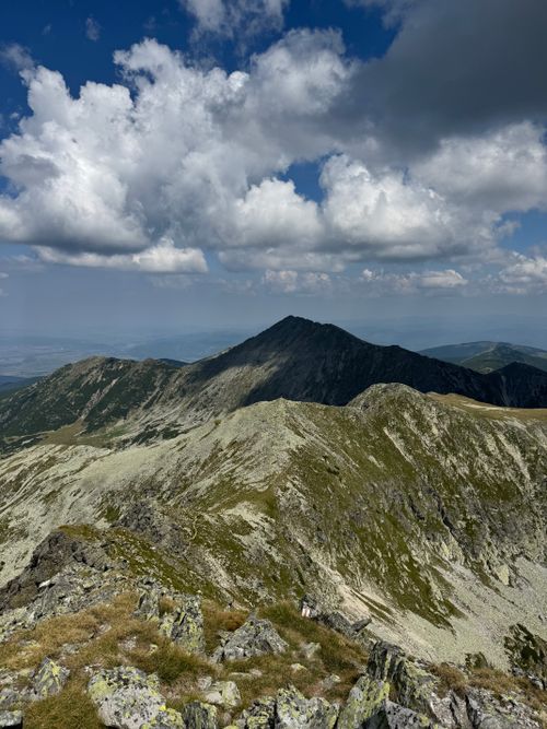 Free Breathtaking view of rocky peaks under a vibrant blue sky with clouds in Parâng Mountains, Romania. Stock Photo