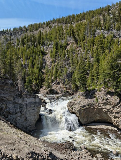 Free Captivating view of a waterfall cascading through rocky terrain in Wyoming's Yellowstone Stock Photo