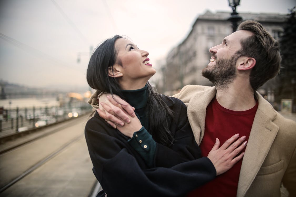 Man in Brown Coat Standing Beside Woman in Black Coat