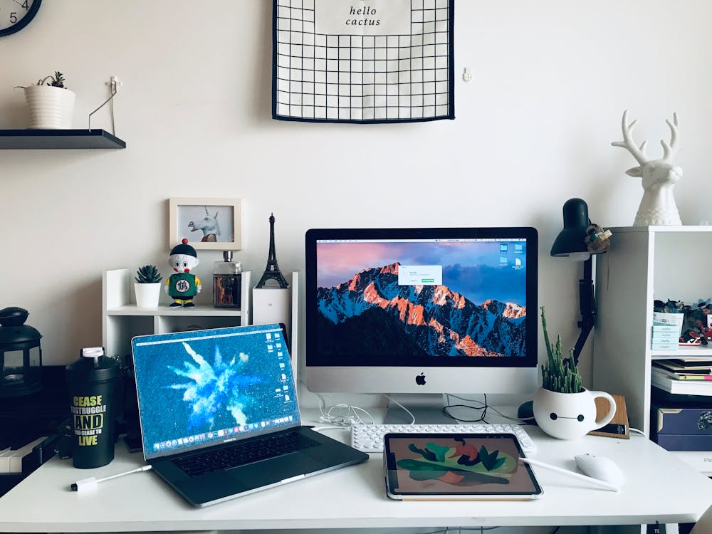 Lampshade Between Computer And White Book Shelves