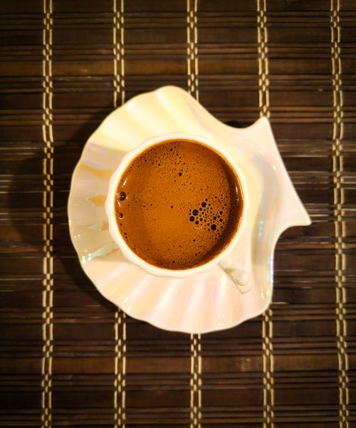 Free A top view of Turkish coffee served in a stylish cup on a bamboo mat, evoking a traditional experience. Stock Photo