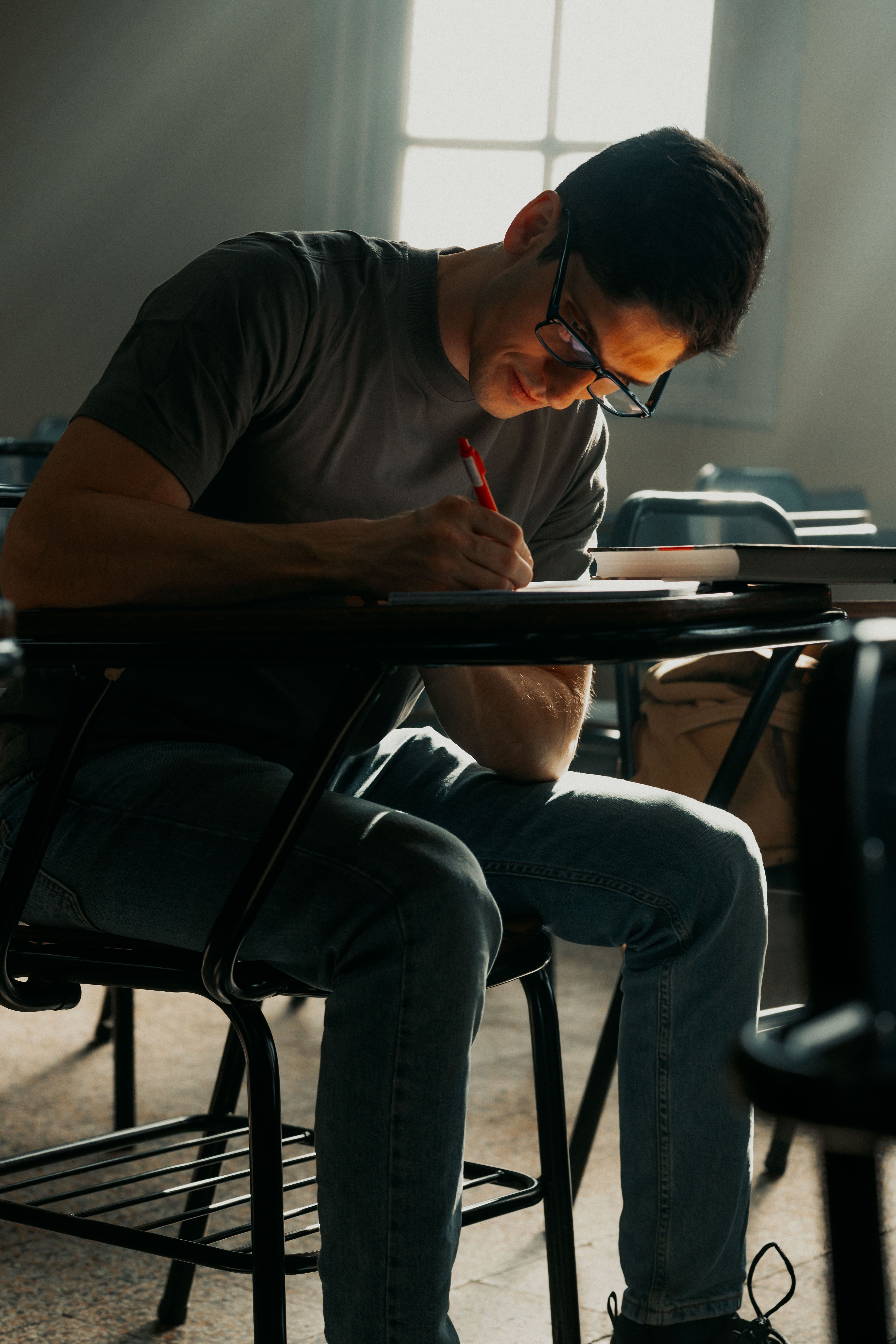 University student studying in classroom with focus · Free Stock Photo