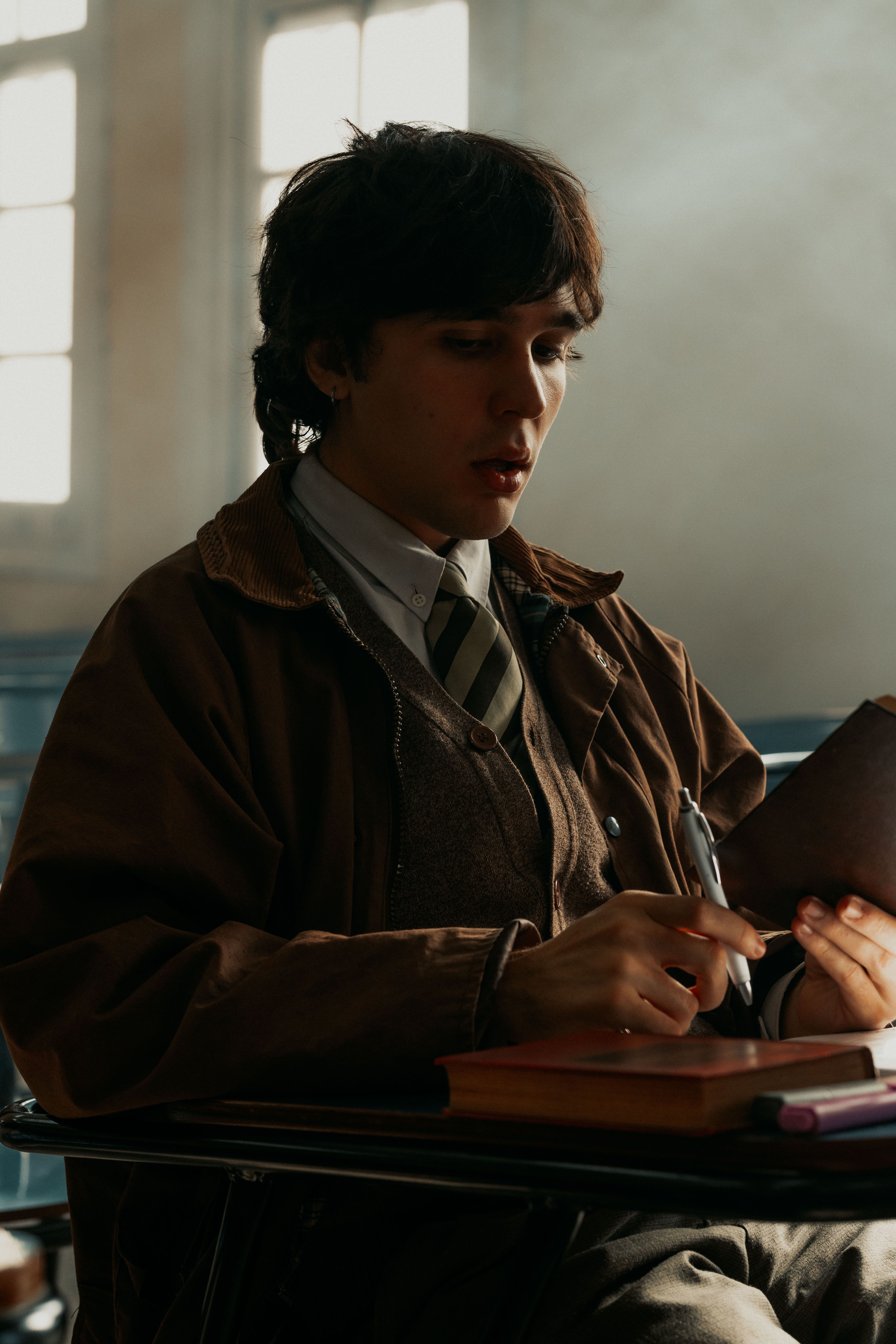 University student reading a book in Buenos Aires, Argentina with focused expression.