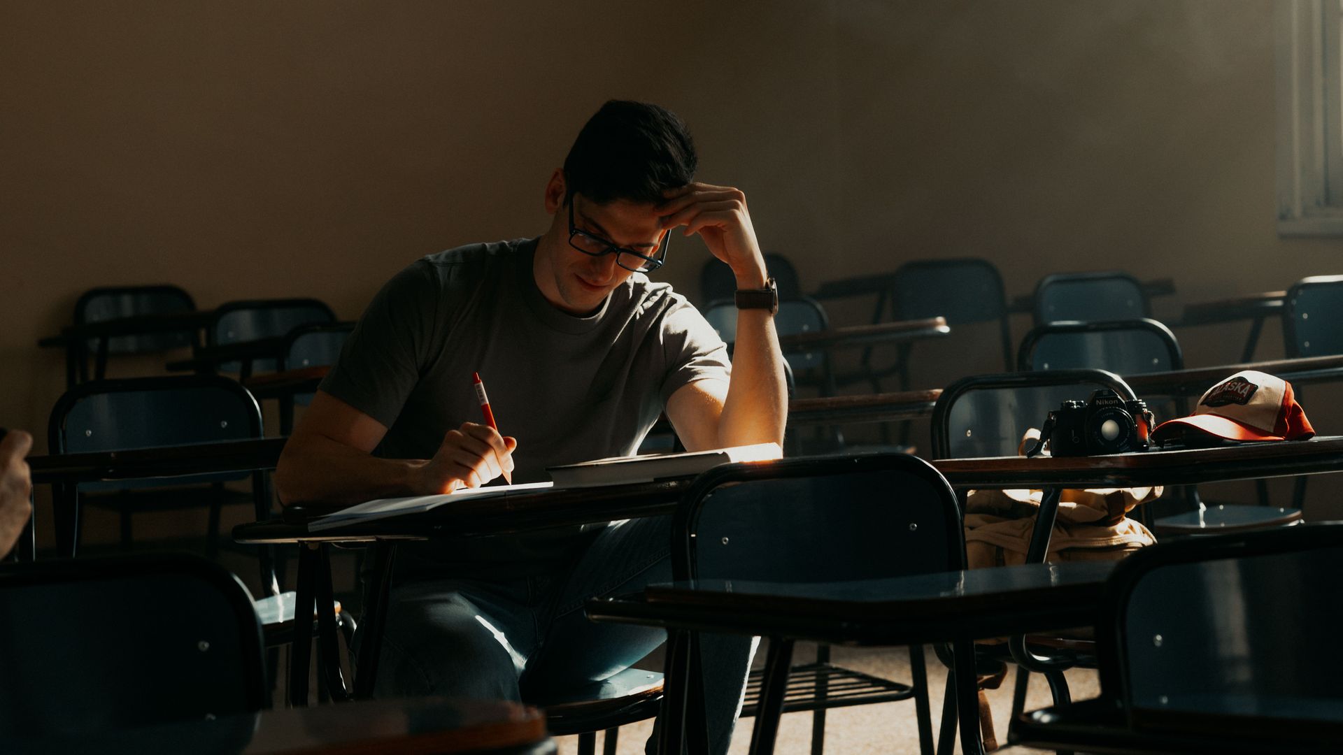 Modafinil for Overnight Exam Cramming: Can It Help? A focused student studying alone in a dimly lit classroom in Buenos Aires, Argentina — modafinil for overnight exam cramming