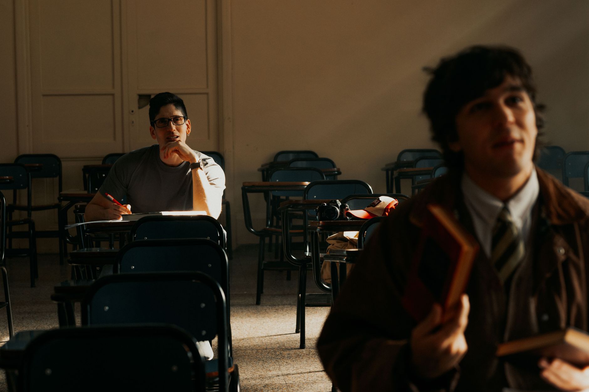 Students in a sunny university classroom in Buenos Aires, deep in thought and study.