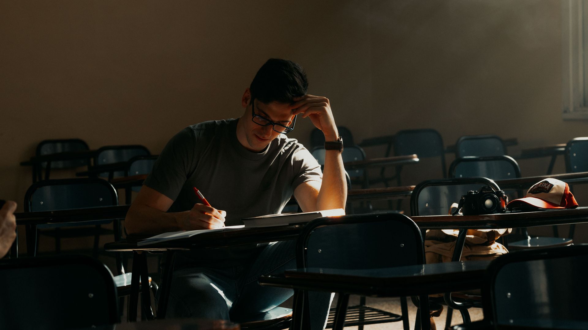 Modafinil for Students Exam Prep: Study Smarter A male student intently studying in a sunny Buenos Aires classroom — modafinil for students exam prep