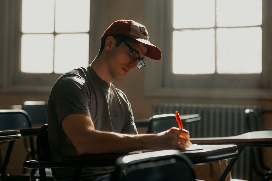 Adult student focusing on writing notes in a Buenos Aires classroom. Adult student focusing on writing notes in a Buenos Aires classroom.