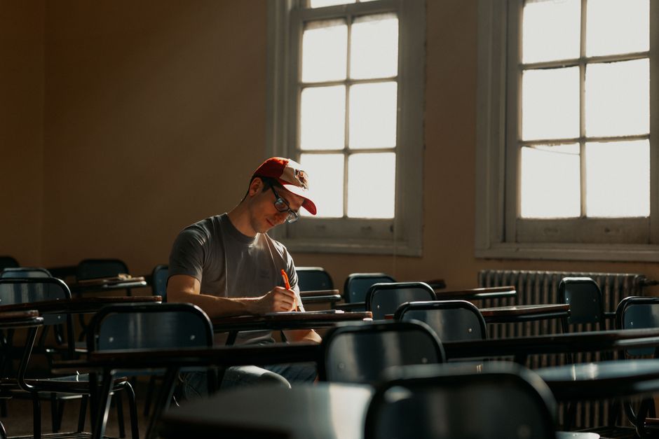 A university student writes notes in a sunlit classroom in Buenos Aires, Argentina. A university student writes notes in a sunlit classroom in Buenos Aires, Argentina.