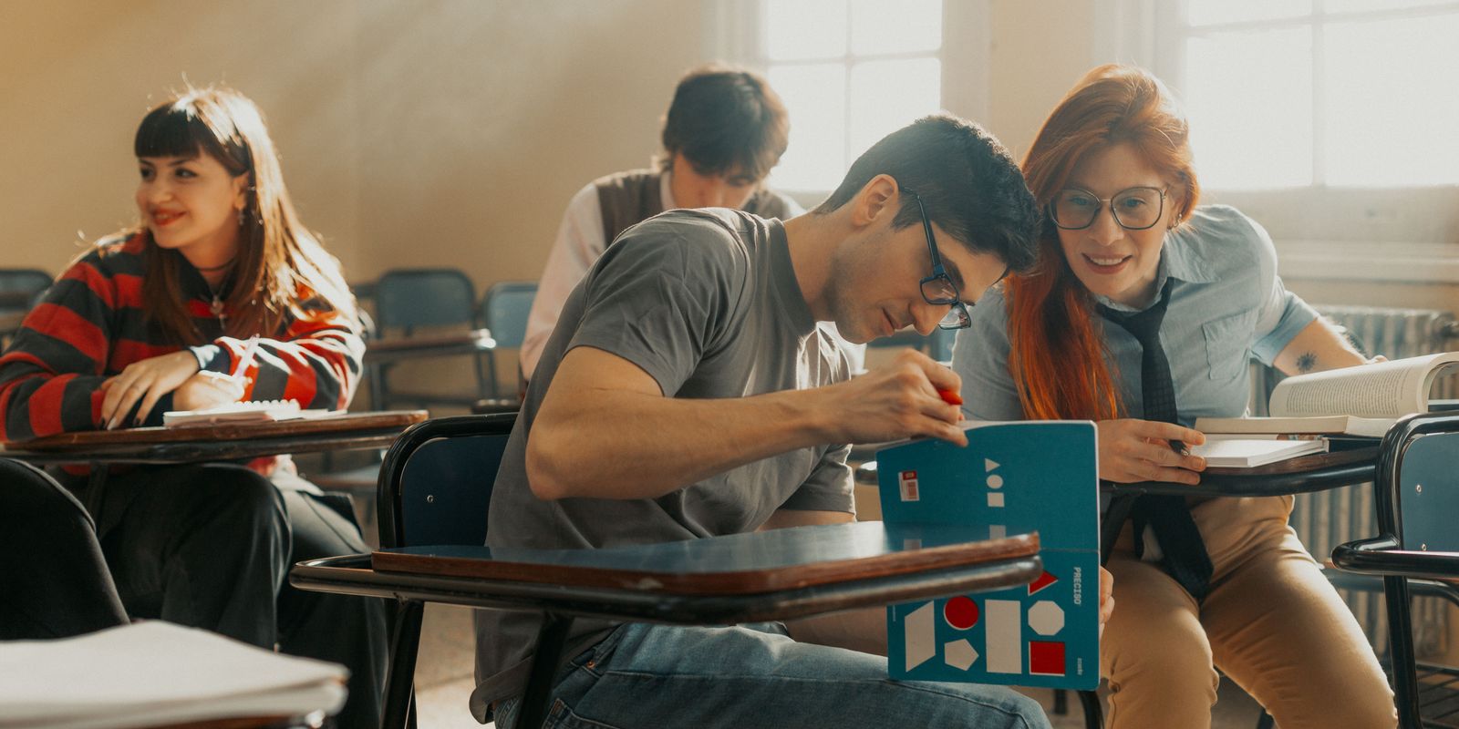University students studying together in a sunlit classroom in Buenos Aires, Argentina.