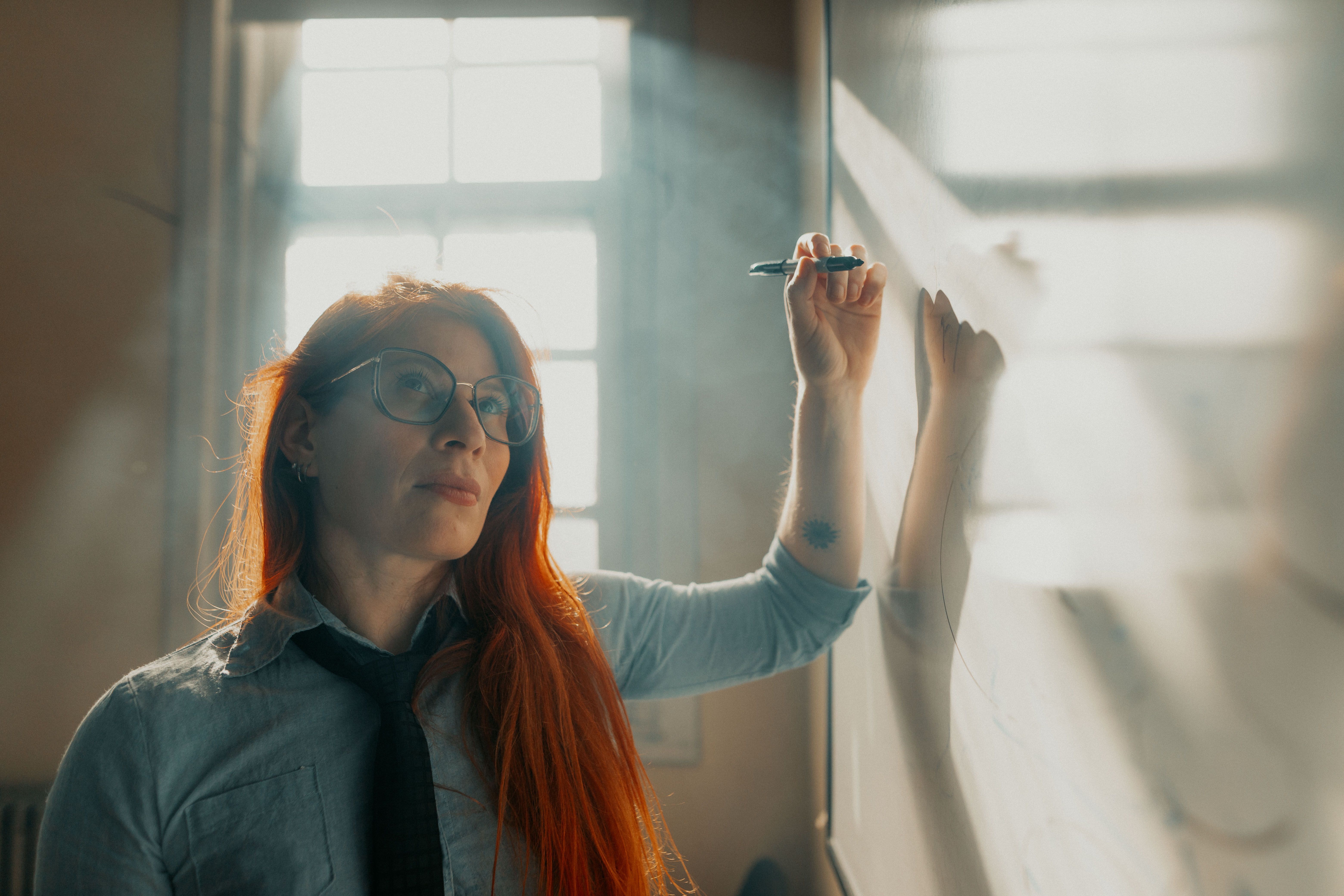 frustrated student sitting in a traditional classroom while a futuristic glowing job market looms outside the window