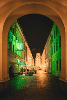 Captivating night shot of a bustling street in Wroclaw, Poland, under glowing lights.