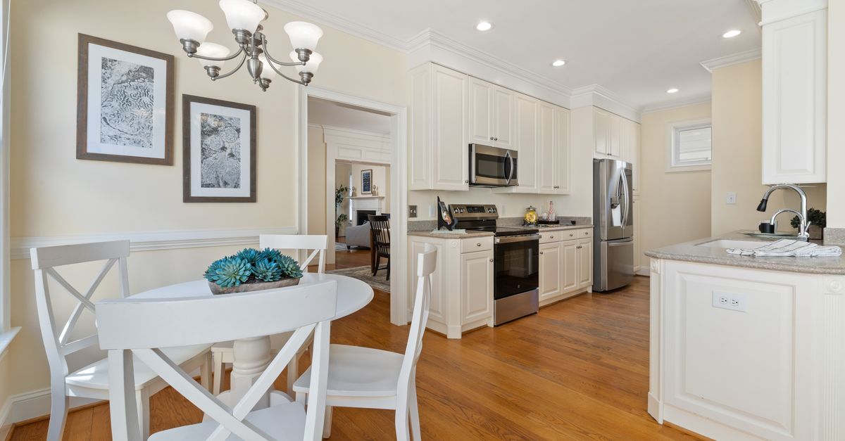 Spacious kitchen with modern appliances and cozy dining area, perfect for family gatherings.