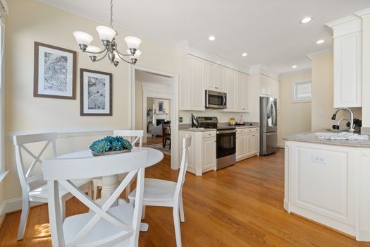 Spacious kitchen with modern appliances and cozy dining area, perfect for family gatherings.