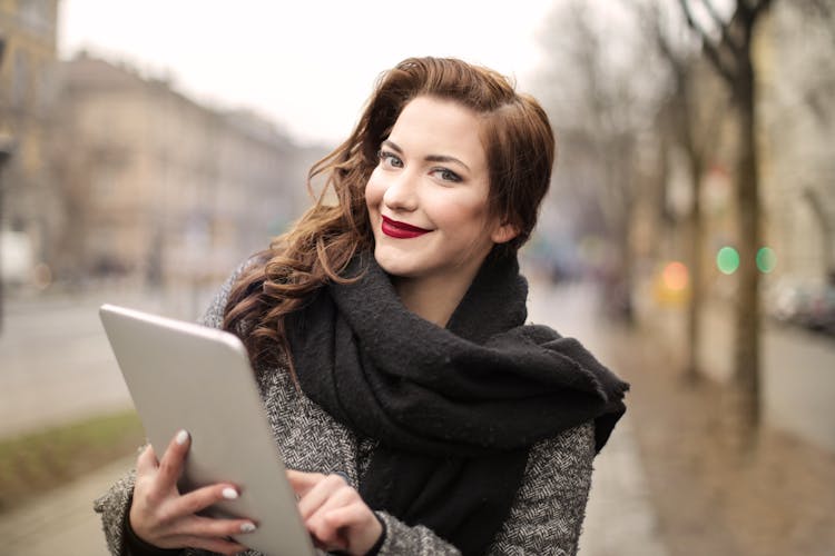 Woman In Black Scarf Holding Silver Ipad