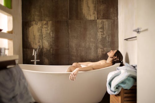 Woman Lying on Bathtub