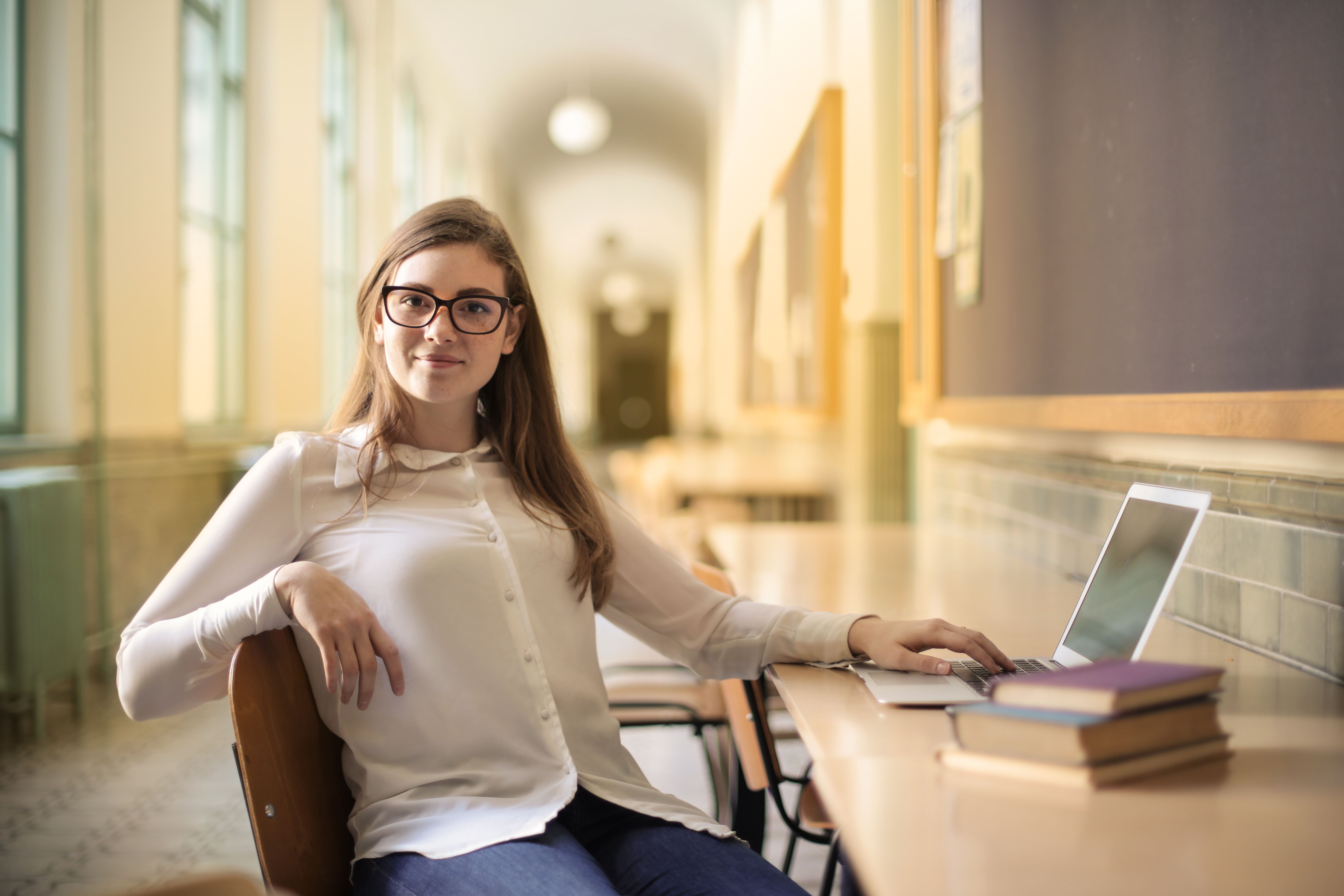 Woman in White Long Sleeve Shirt Sitting on Chair · Free Stock Photo