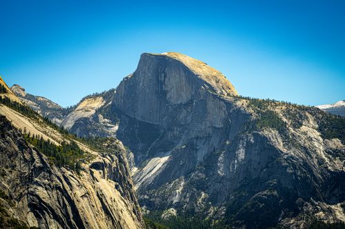 Free Majestic Half Dome rock formation in Yosemite under a clear blue sky, showcasing rugged beauty. Stock Photo