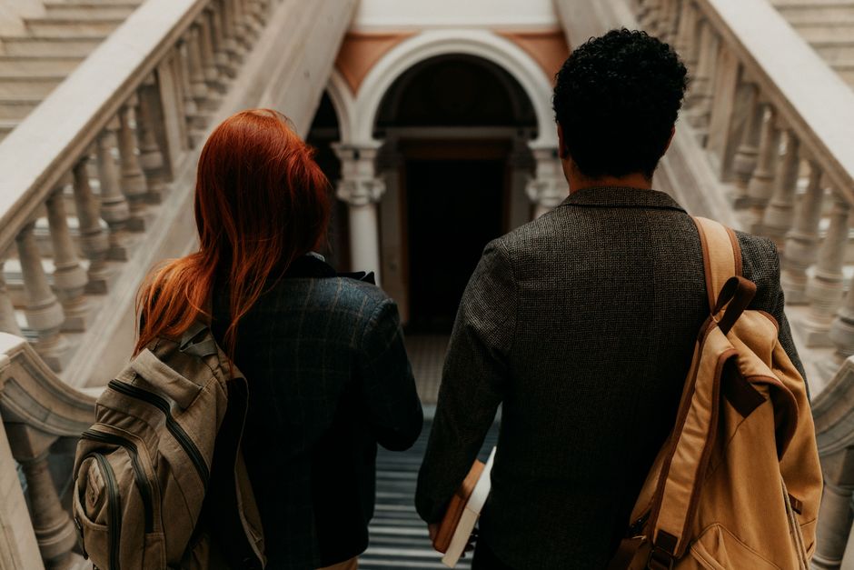 Two students walking through a historic university hallway in Buenos Aires. Two students walking through a historic university hallway in Buenos Aires.