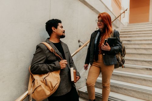 Free Adult students discussing in a university building on a marble staircase in Buenos Aires. Stock Photo
