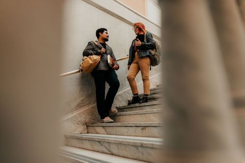 Free Two students engaging in conversation on campus stairs, Buenos Aires, Argentina. Stock Photo