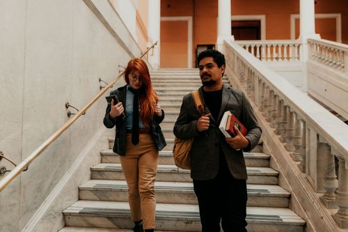 Free Two university students walking down stairs in a historic building in Buenos Aires, Argentina. Stock Photo