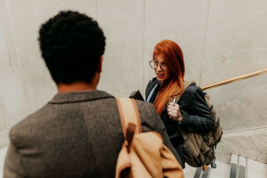 Two students in conversation on a university staircase, Buenos Aires, Argentina.