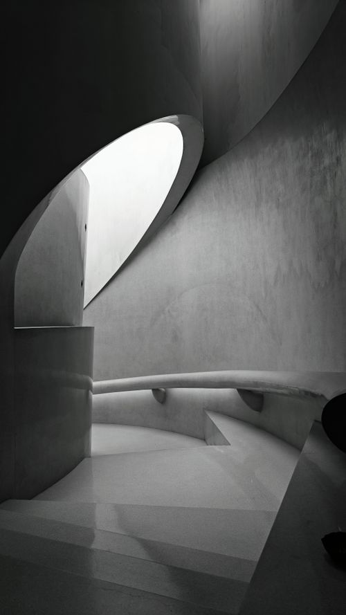 Free Striking minimalist spiral staircase in grayscale tones, showcasing modern architectural design. Stock Photo