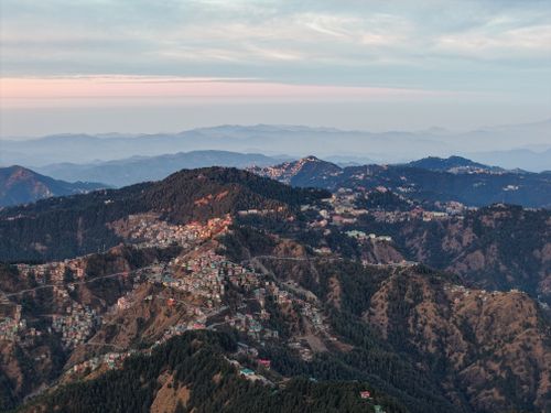 Free Stunning aerial view of Shimla, India showcasing the expansive mountainous landscape at sunset. Stock Photo