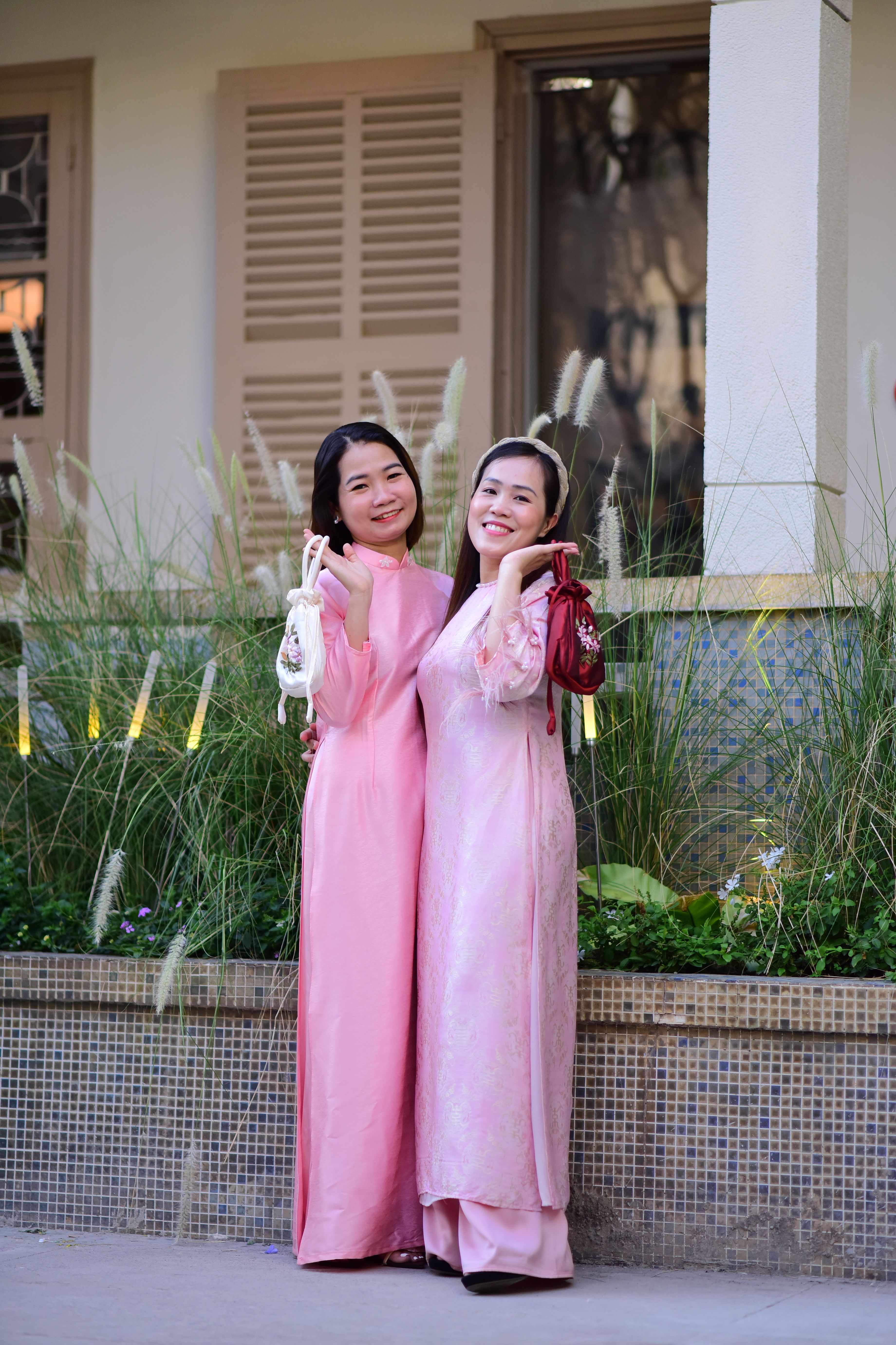 Two Smiling Women in Traditional Pink Dresses Outdoors · Free Stock Photo
