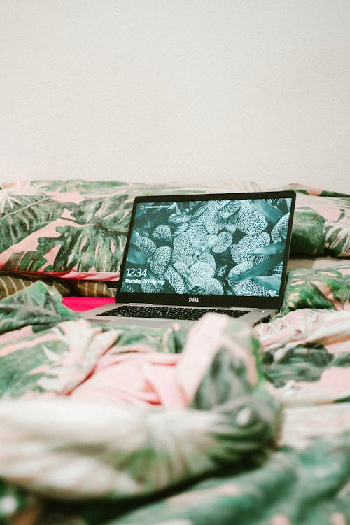 Free Black Laptop Computer on Bed Stock Photo