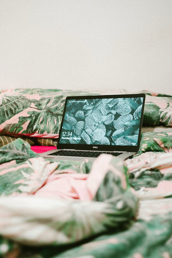 Black Laptop Computer on Bed