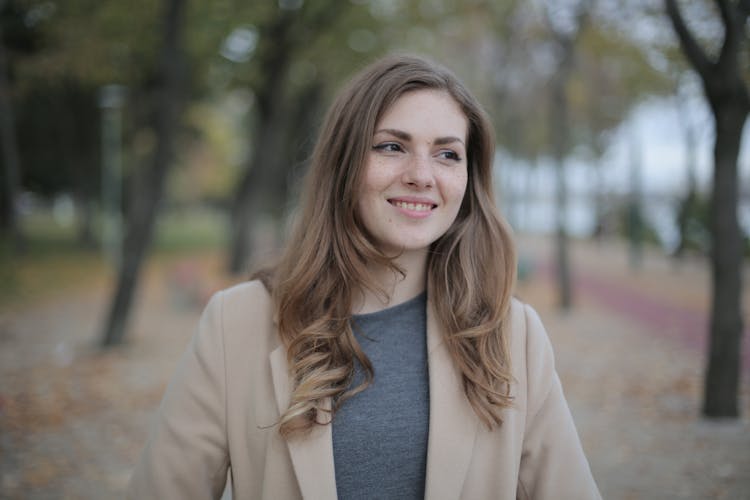 Joyful Young Modest Woman Walking Alone In Park