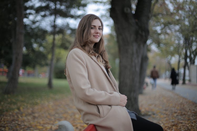 Gladful Young Woman Chilling In Autumn Park