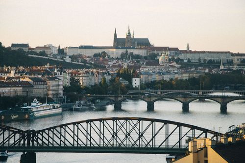 Free Scenic view of Prague's historic skyline, featuring the Vltava River and Prague Castle at sunset. Stock Photo