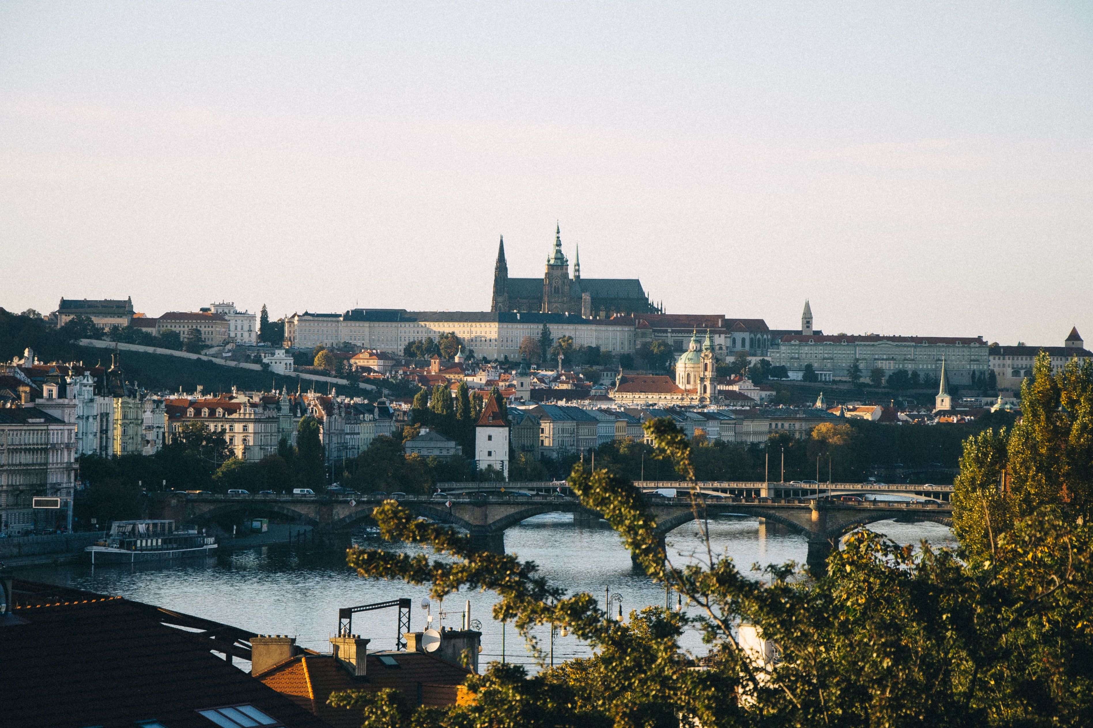 Capture of Prague Castle over Vltava River showcasing classic Czech architecture at dusk.