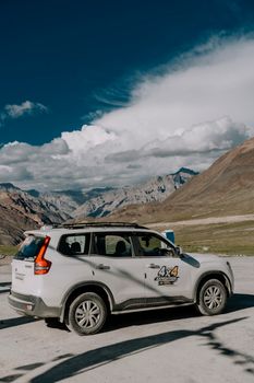 4x4 SUV parked in stunning mountain landscape under clear sky, showcasing outdoor adventure.