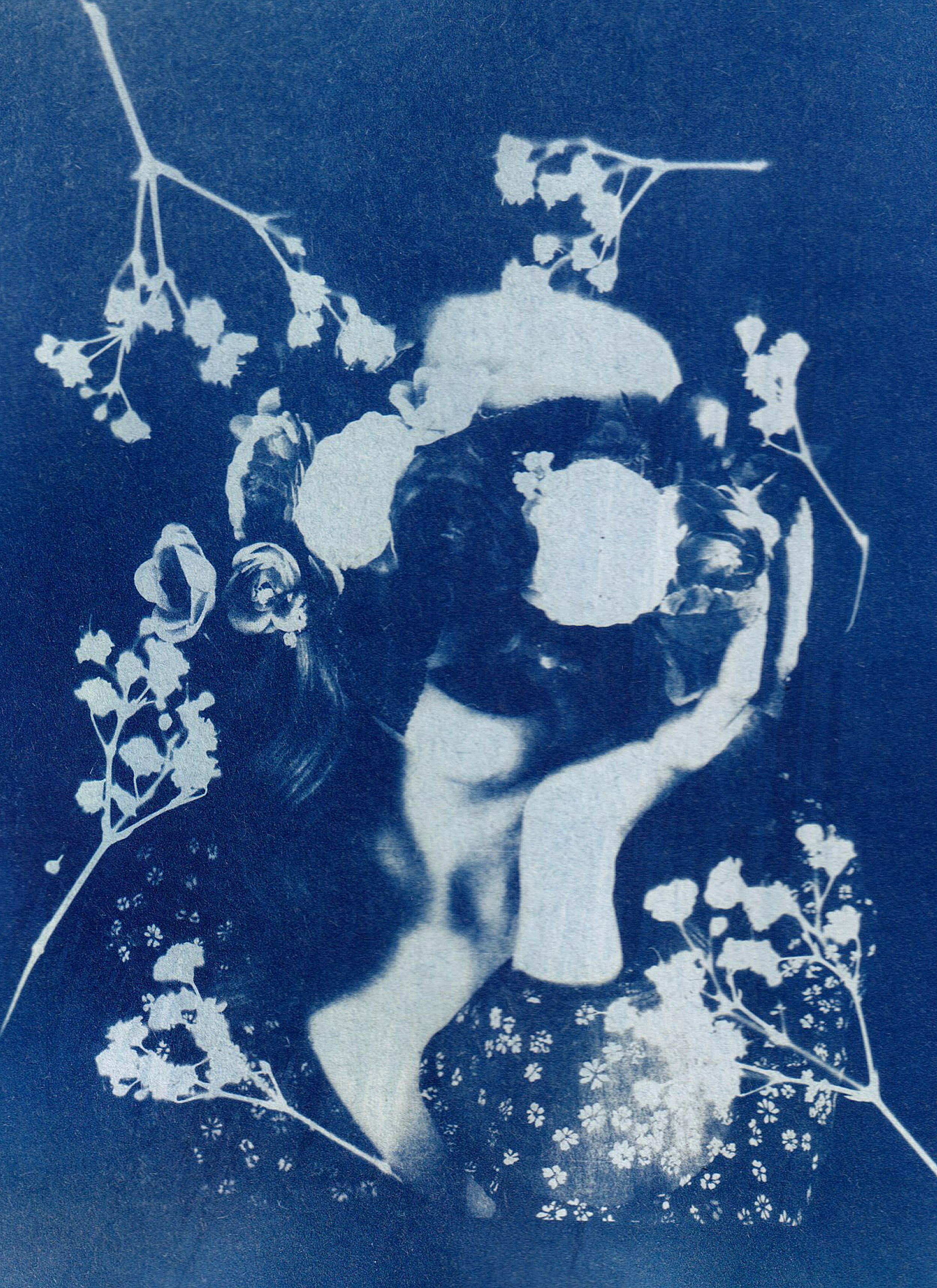 A creative cyanotype portrait featuring floral overlays, evoking an artistic and vintage feel.