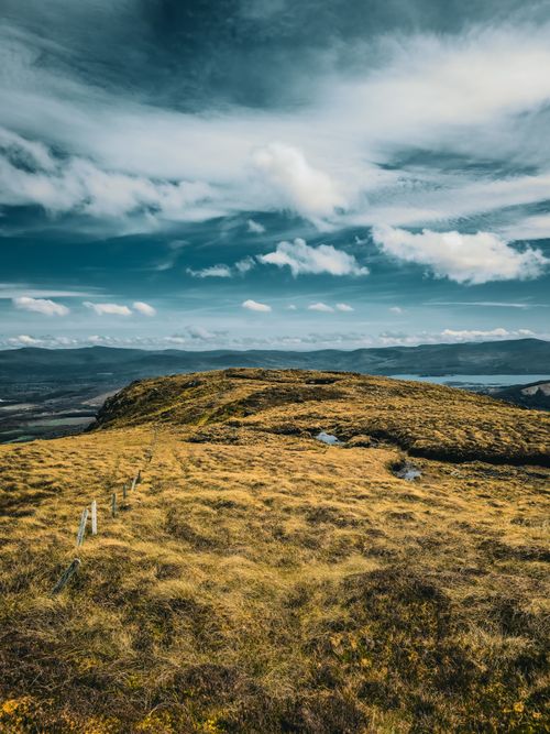 Free Scenic view of lush green hills and dramatic sky in Ireland, perfect for travel themes. Stock Photo