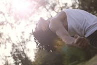 Ethnic man doing exercise in park