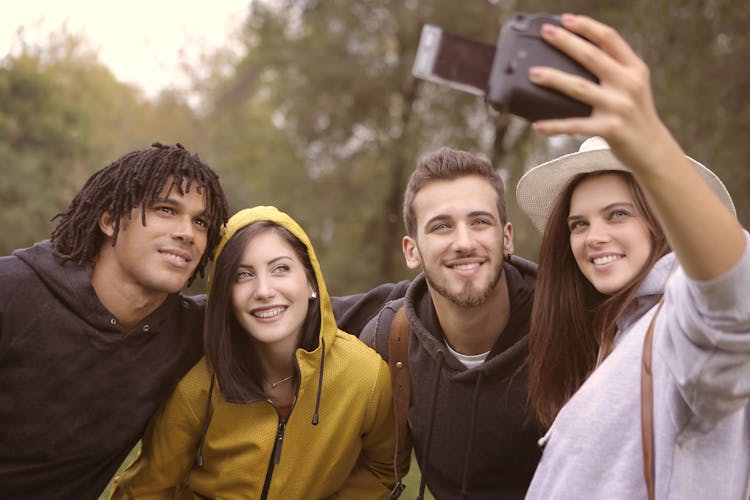 Happy Diverse Friends Taking Selfie In Park