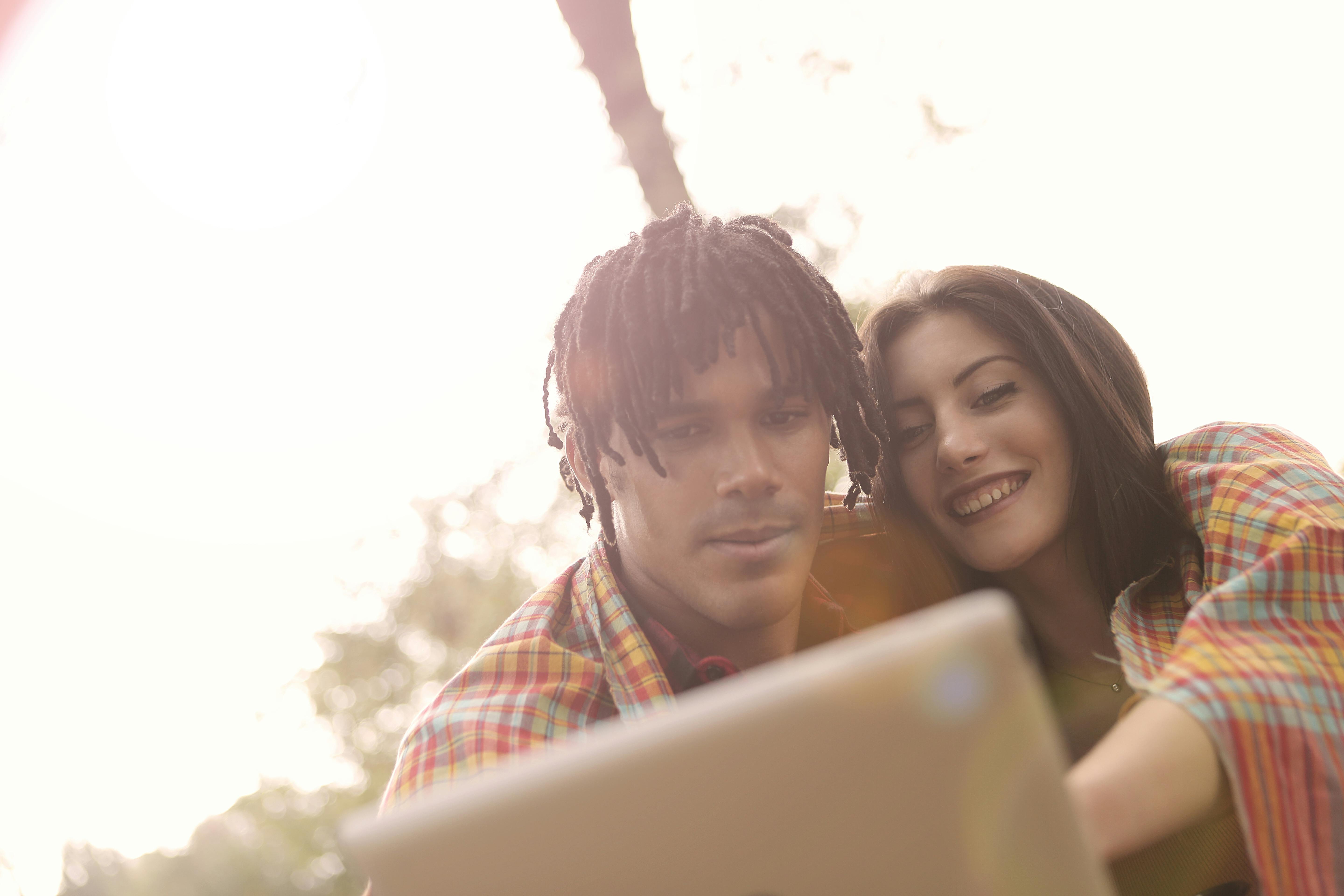 serious man sitting beside a happy woman