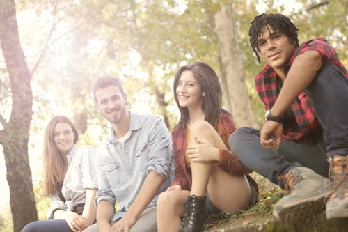 Photo of People Sitting While Smiling