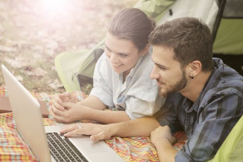 A Happy Couple Using Computer Laptop