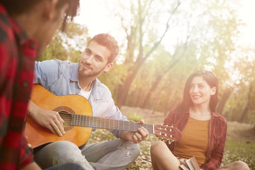 Free Divers friends having fun with guitar Stock Photo