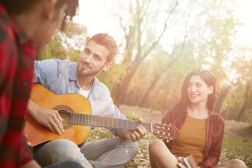 Divers friends having fun with guitar