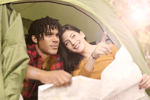 Man and Woman Holding Map Looking Destination