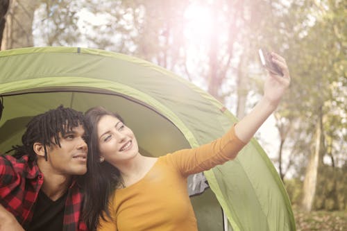 Free Man and Woman Taking Selfie Using Smartphone Stock Photo