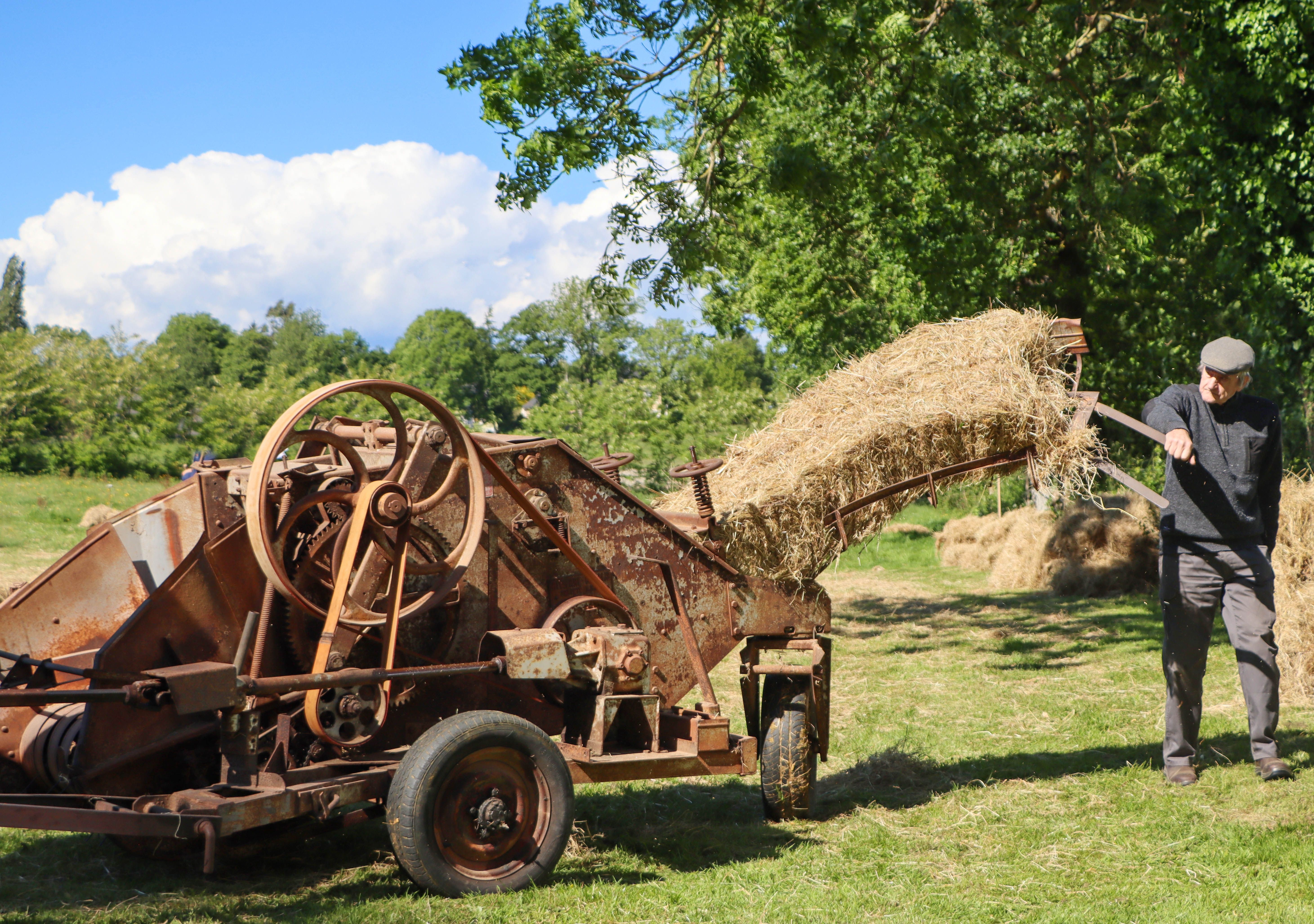 Retired square baler with seized knotter and missing twine arm sitting in an Arkansas hay barn