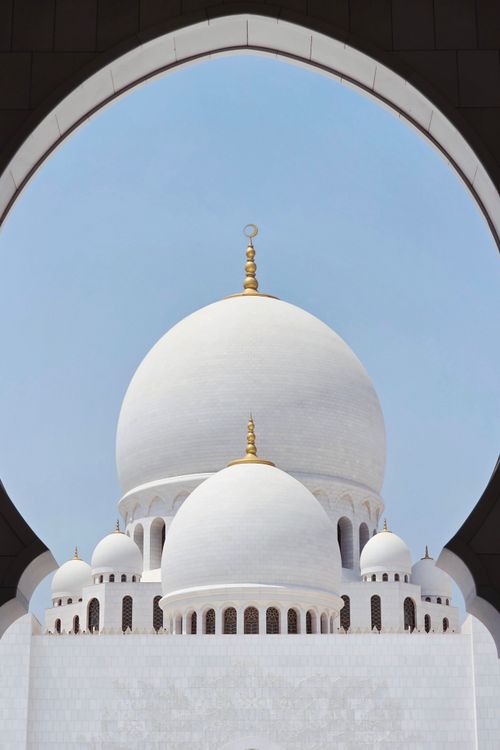 Free A striking view of the iconic domes of Sheikh Zayed Grand Mosque in Abu Dhabi. Stock Photo